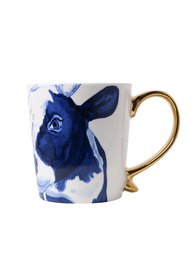 A blue and white ceramic mug with a cow design and a gold handle.