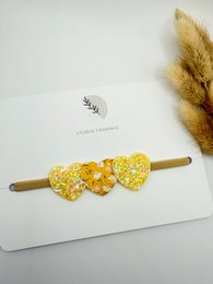  Yellow floral hairband with a spring-inspired design, suitable for kids.