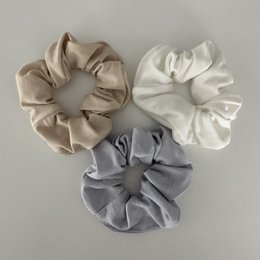Cream-colored bamboo scrunchie with a soft, textured fabric.