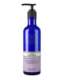  A blue glass bottle with a black pump dispenser, containing a citrus-scented hand wash from Neal's Yard Remedies. The 200 ml bottle is designed for bathroom use.