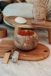 Decorative palm-shaped candle holder with intricate carved patterns, made of natural materials, suitable for home decor and ambiance.