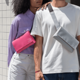 A stylish crossbody bag available in black, green, burgundy, and orange. The bag features a sleek, rectangular shape and an adjustable shoulder strap for comfortable wear.