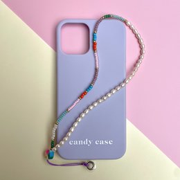 Multicolored pearl-like smartphone case with a decorative cord strap.