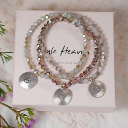 This crystal bracelet features a delicate lotus charm and gold-toned beads, creating a beautiful and elegant accessory.
