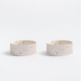 Two round, speckled pet food bowls in white color. Suitable for serving pet food or treats.