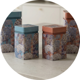 Decorative metal storage boxes with mandala pattern, available in two sizes, suitable for storing small items.