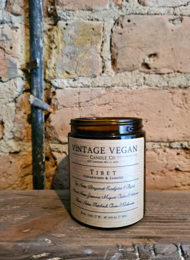 Vintage vegan soy wax candle with cedarwood and jasmine scent, in a glass jar with a rustic label.