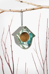  Colorful recycled birdhouse with natural materials and geometric shapes.