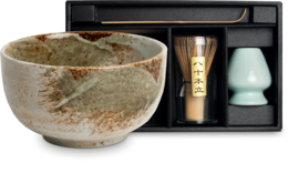 Large matcha bowl with whisk and accessories in gift box. Ceramic bowl with natural speckled glaze finish. Includes matcha whisk, scoop, and tea caddy.