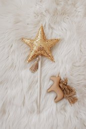 Gold star-shaped wand with glitter, suitable for kids' imaginative play.