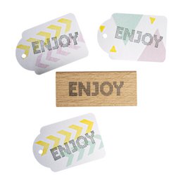 Wooden stamp with the word "Enjoy" printed on it, along with stars and arrow designs. This office supply item can be used to add decorative elements to documents, cards, or other paper-based projects.