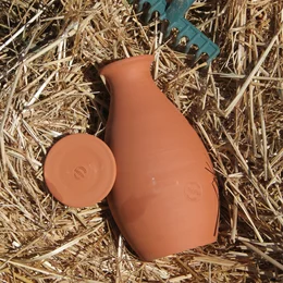 Terracotta vegetable garden olla, available in 4 litre and 1.5 litre sizes, for burying in the soil to provide slow-release watering for plants.