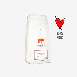 A bag of George Street Blend coffee, featuring a red heart icon and the text "House Blend" on the front. The packaging also includes details about the coffee blend on the back.