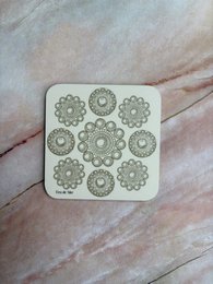  Coasters featuring a repeating pattern of intricate, circular designs in a neutral color scheme. The coasters have a simple, minimalist style that would complement a variety of home decor.