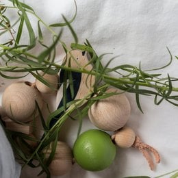 Wooden teether with long-tailed tit design, made of natural materials, suitable for baby's teething needs.
