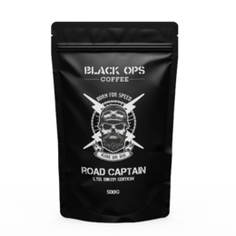 Dark roasted coffee beans in a black package with a skull and crossbones logo, labeled "BLACK OPS COFFEE ROAD CAPTAIN"