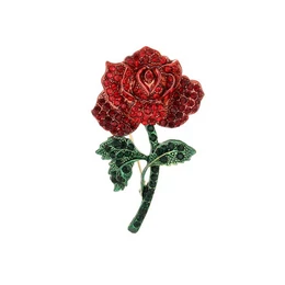Red glittery rose flower brooch with green stem and leaves, sparkly textured design