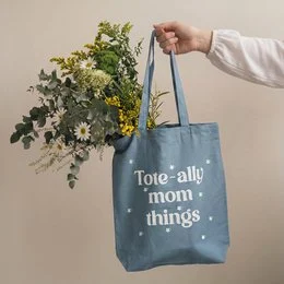 Blue canvas tote bag with "Tote-ally mom things" text print, spacious shopping bag for mothers