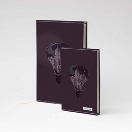A5 and A6 sized notebooks with a dark, minimalist design featuring an abstract skull-like graphic. The notebooks are made of Tyvek material and come in a variety of color options.