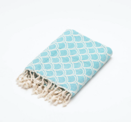 Soft, absorbent peshtemal beach towel in a turquoise and white scalloped pattern. Made of 100% Turkish cotton, perfect for the beach, pool, or spa.