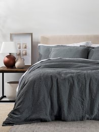 Wrinkled gray coverlet in twin, queen, and king sizes. Made of soft, textured material with a relaxed, casual style.