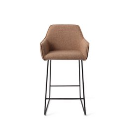 Jesper Home Hofu Barkruk Slide Black (counter) - A modern, upholstered bar stool with a sleek black metal frame and a comfortable, textured beige seat. Suitable for use at a kitchen counter or bar.