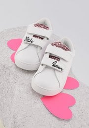 White leather kids' shoes with pink accents, featuring the text "Little Sister" and a heart-shaped design.