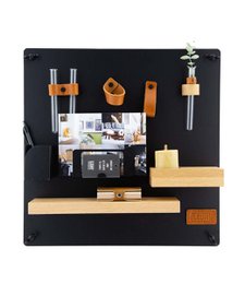 Circular wall organizer with various compartments and hooks for storage and organization. Made of black and natural wood materials.