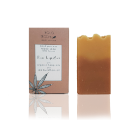 Eco-friendly facial soap bar with natural ingredients. Rectangular shape, brown color, and leaf design on packaging.