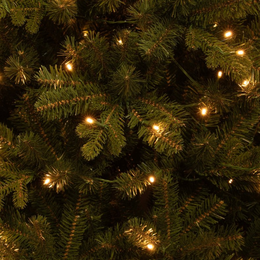  A tall, slender artificial Christmas tree with green foliage and warm white LED lights, perfect for adding festive cheer to any space.