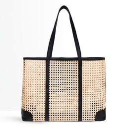 Beige and black woven shoulder bag with zipper pockets and tassels.
