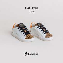 Casual sneakers with a zipper on the inside, featuring a white leather upper with leopard print accents. Suitable for kids' sports activities.