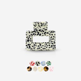 Leopard print hair clip with a bow design, made of a soft, flexible material.