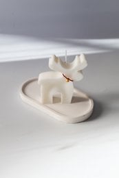 Tall, round, white soy wax candle in the shape of a deer.