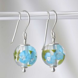 Dark sky blue glass flower drop earrings with silver hooks.