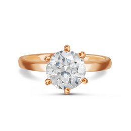 A classic rose gold engagement ring with a round brilliant cut diamond center stone. The ring features a six-prong setting and a simple, elegant design.