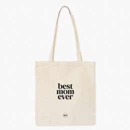 A white cotton tote bag with the text "de leukste JUF" (Dutch for "the nicest teacher") printed in black. The bag has a simple, minimalist design and appears to be a stylish accessory or gift for a teacher.