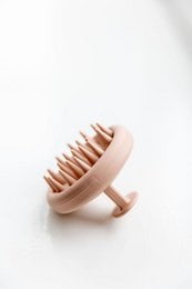 Scalp massager with soft silicone bristles for gentle scalp stimulation and improved blood circulation.