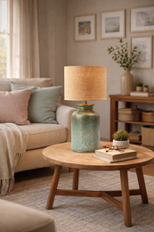  A green ceramic table lamp with a metallic silvery/antique golden finish and a rafia/rattan drum shade.