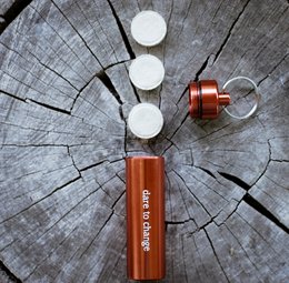 Outdoor edition baby wipes in orange and green containers with white lids.