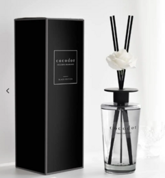 Black reed diffuser with floral accents, available in 500ml size and various scents including White Musk, Black Cherry, Pure Cotton, April Breeze, Garden Lavender, and Vanilla & Sandalwood.