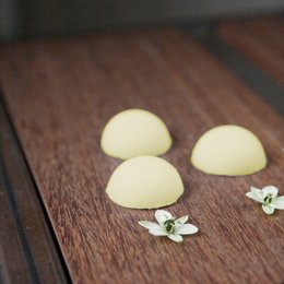 Soothing baby bath melts made with natural ingredients for a gentle, zero-waste cleansing experience. Features round, white bath bombs with floral accents.