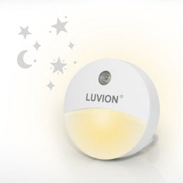 Circular white night light with moon and star design, providing soft, warm illumination for a child's bedroom.