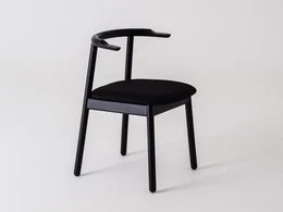 A modern, minimalist dining chair with a black upholstered seat and a sleek, angular black wooden frame.