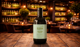  Extra virgin olive oil, early harvest, green bottle, olive grove background, wooden table, olives, olive oil.