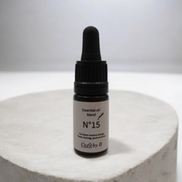 Essential oil No.15 with notes of orange flower, jasmin, and tonka bean. Packaged in a dark glass bottle with a dropper.