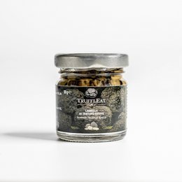 Slices of summer truffle, 30 gr, in a glass jar with a silver lid. The truffles appear to be dark in color with visible pieces inside the jar.