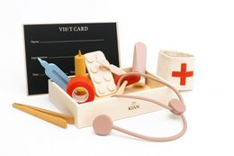  Wooden toy doctor's kit with various medical instruments including a stethoscope, bandages, and a thermometer. The kit is designed for imaginative play and learning.