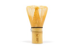 Bamboo matcha whisk, used for preparing traditional Japanese matcha tea. Features a natural bamboo handle and tines for frothing and blending matcha powder.