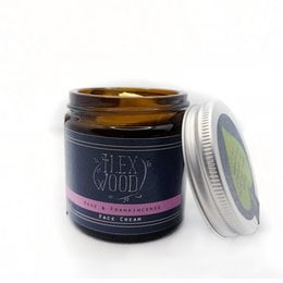 Rose and Frankincense face cream in a 60ml jar with a dark gray label.